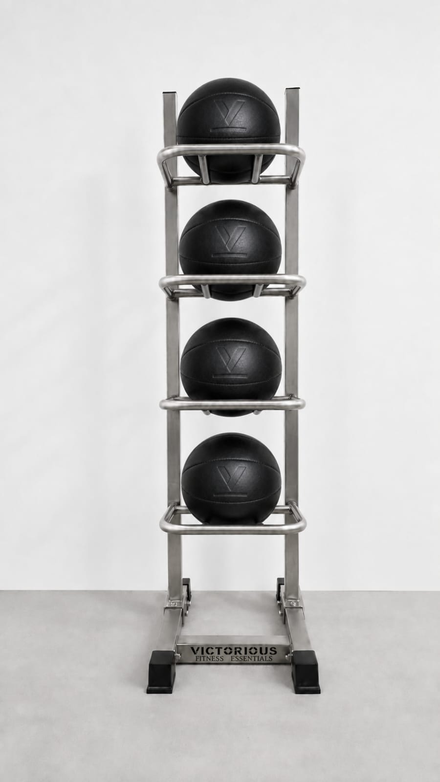 A stainless steel 4-tier medicine ball rack holding four black medicine balls.